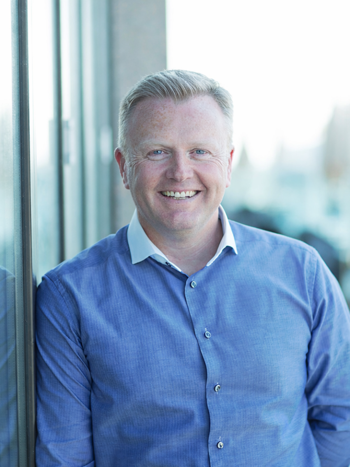 Man smiling by a window 1